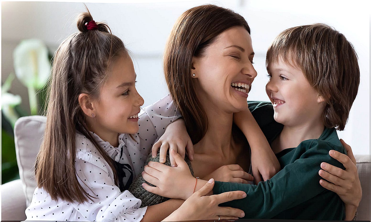 Mother hugging and dedicating phrases of love to her children.