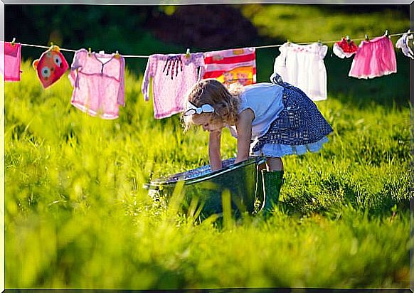 girl hanging clothes