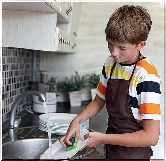 teenager washing dishes