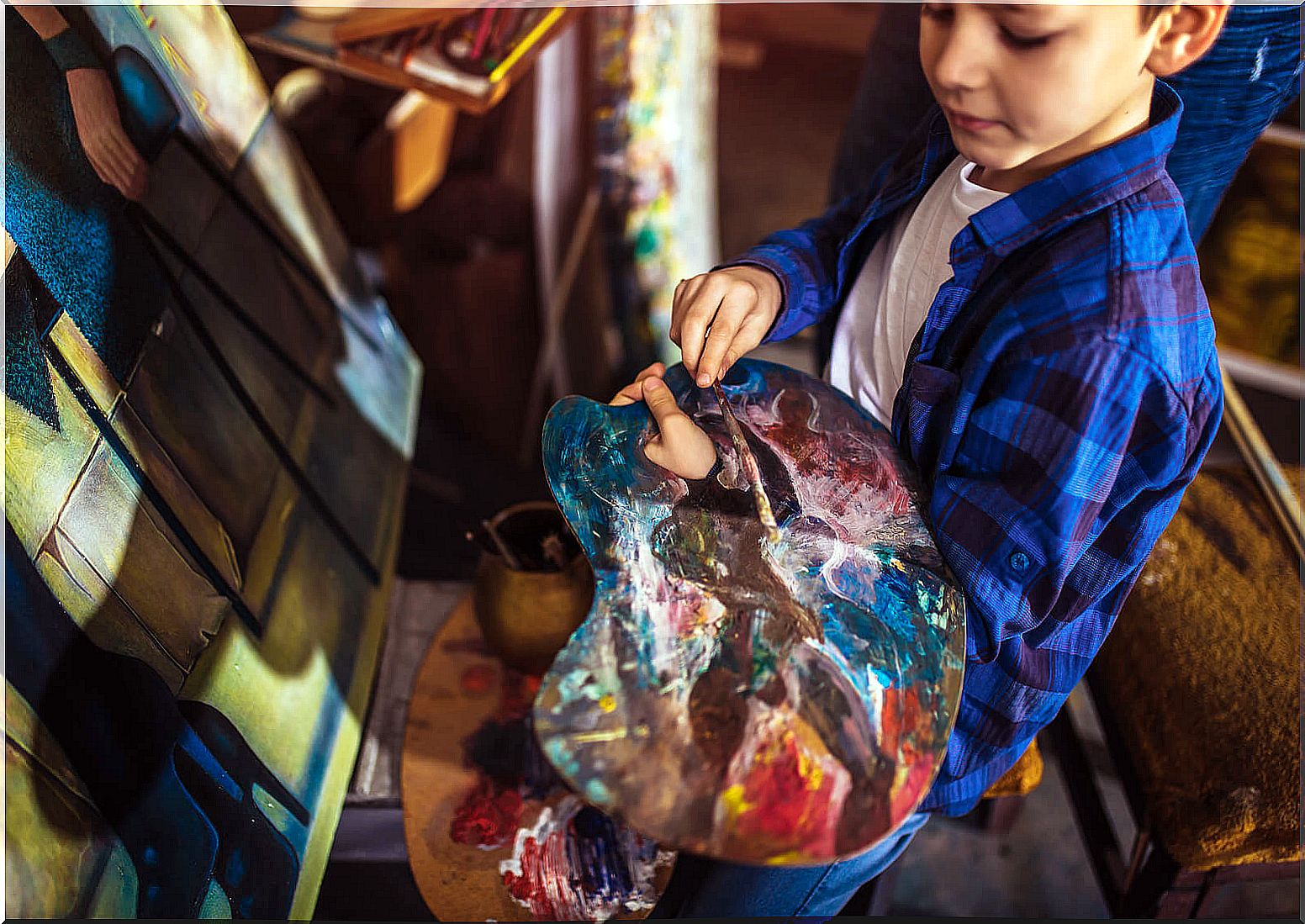 Child painting in an art workshop.