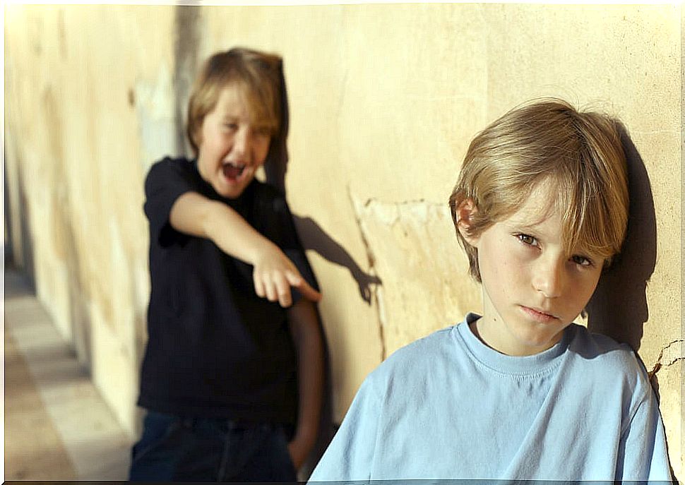 Boy teasing another classmate at school.