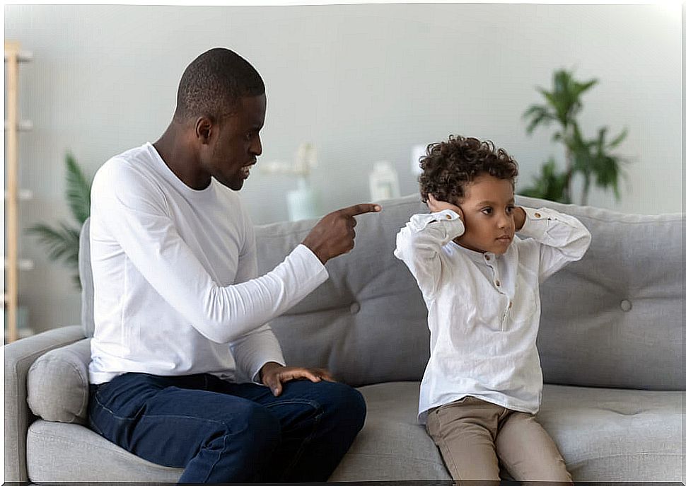 Father scolding his son trying to avoid yelling at his son.