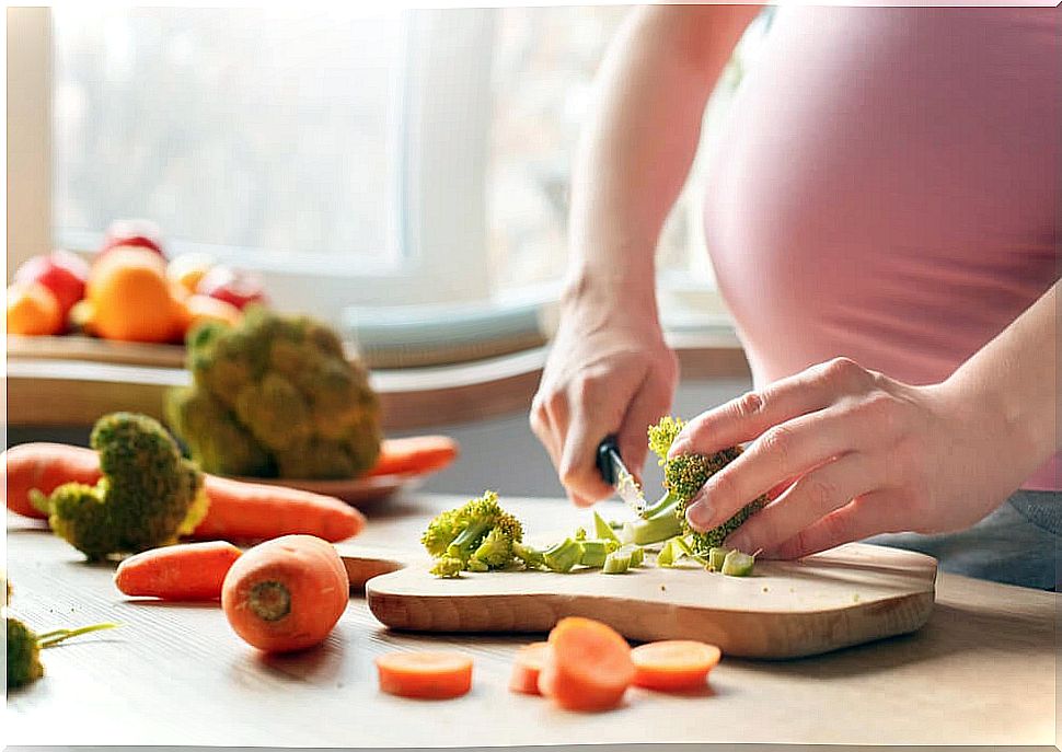 Woman cooking food with basic nutrients to have a good pregnancy.