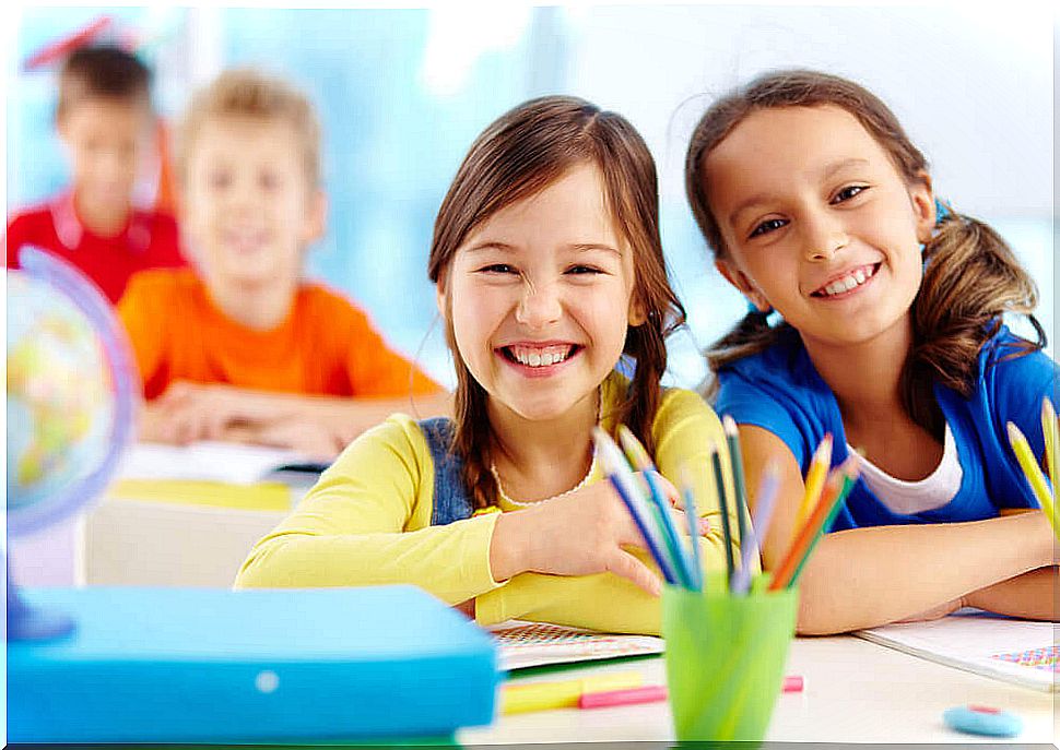 Happy girls in class after changing schools.