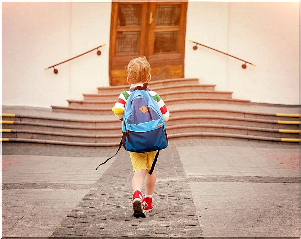 Boy going to class in his new school after the change to a new one in the European Union.