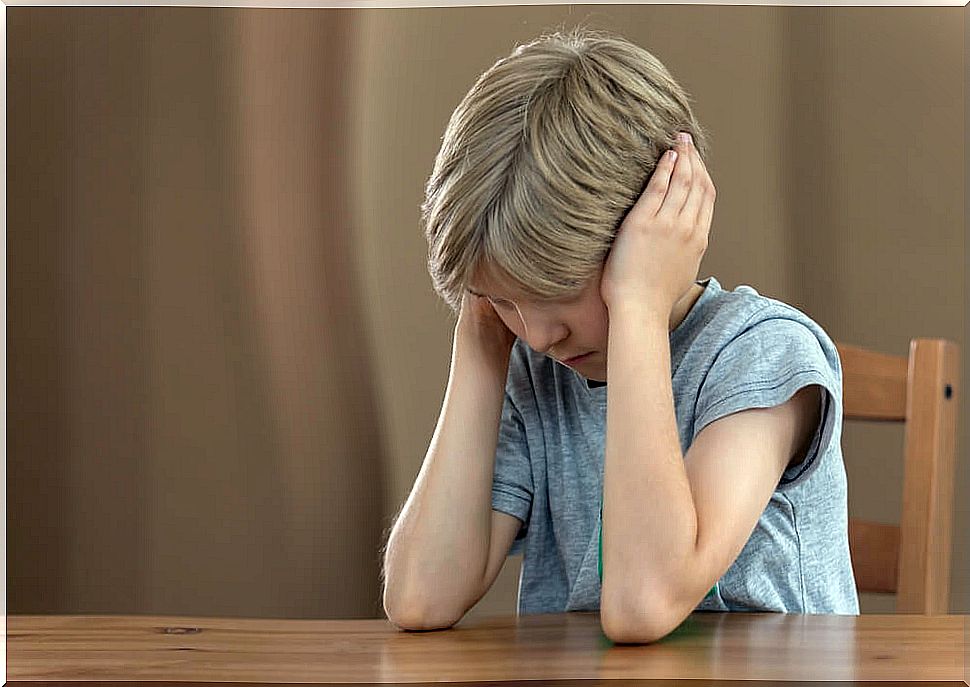 Highly sensitive child upset and covering his ears with his hands so as not to listen.