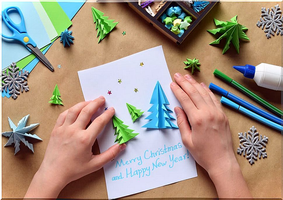 Decorating Christmas cards with cardboard trees.