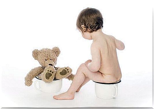 toddler and teddy bear sitting on potties