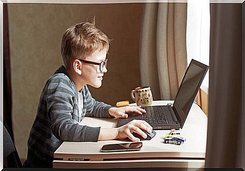 Boy using Kiddle search engine to do his homework.