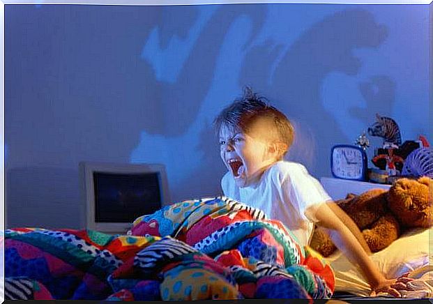 Boy in his bed screaming in the middle of the night because he has nightmares.