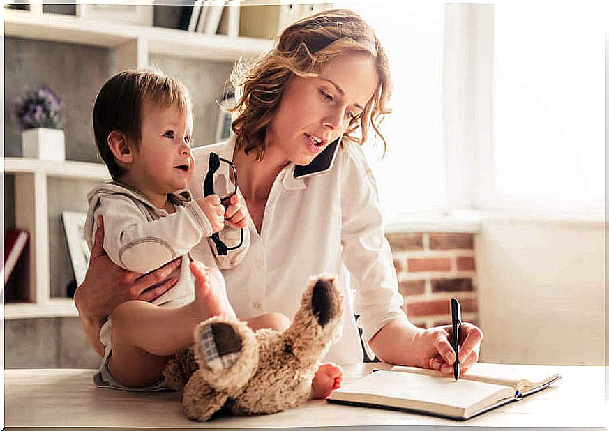 Mother with her son working at home for self-demand in motherhood.