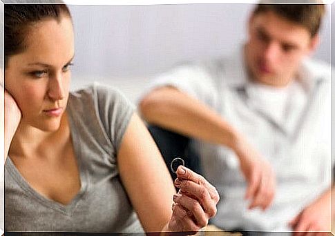 Woman with her ring in hand after divorce.