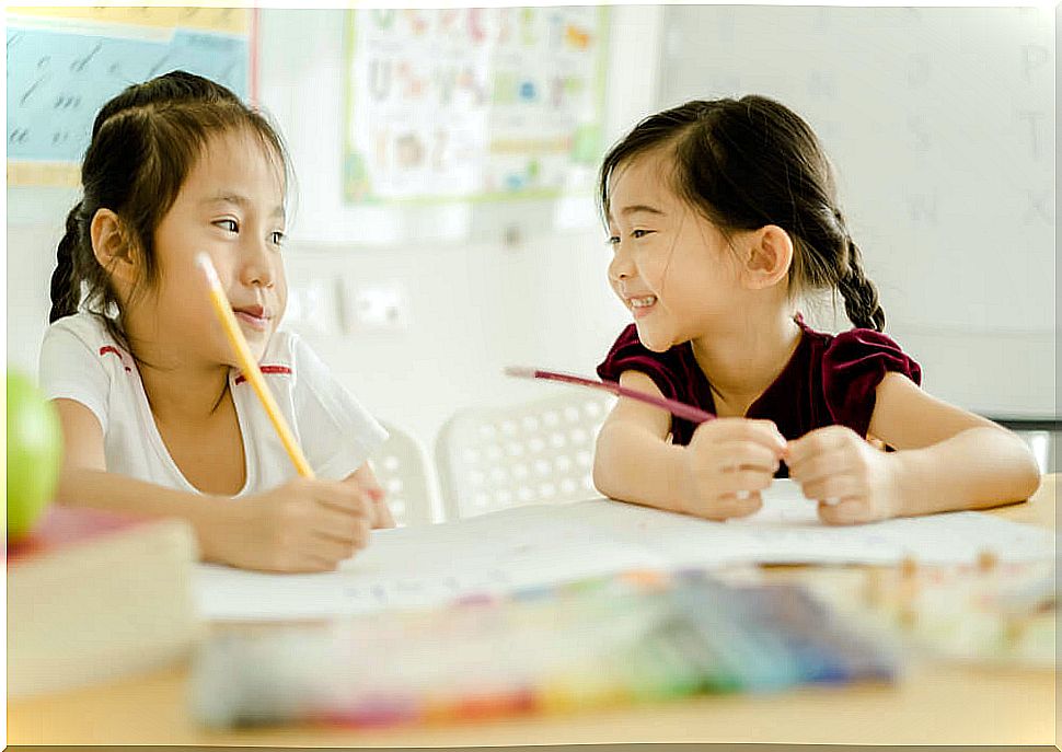 Girls learning to read and write according to Montessori.