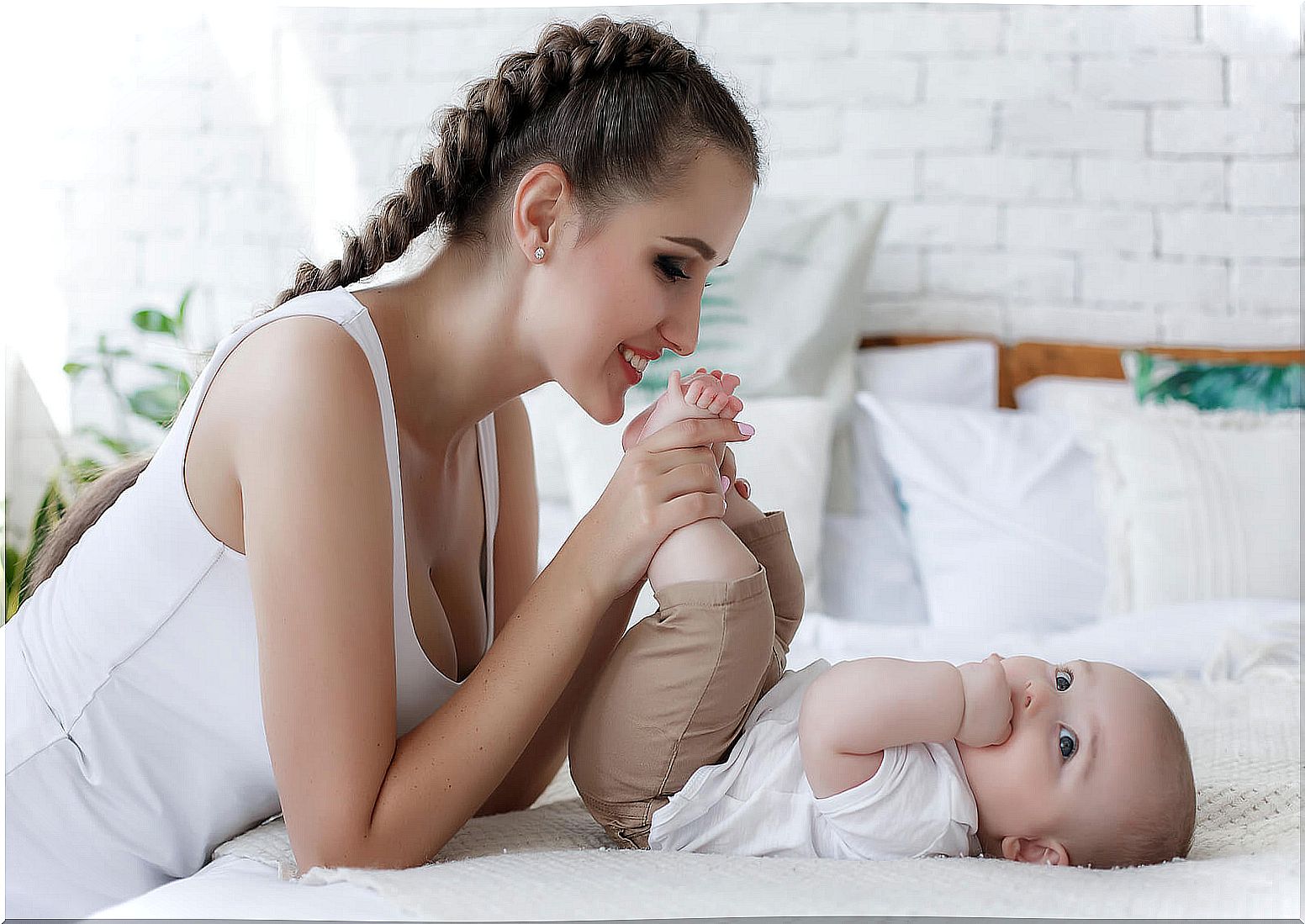 Mom playing with her babies because she knows that the first years of the baby are key to their future.