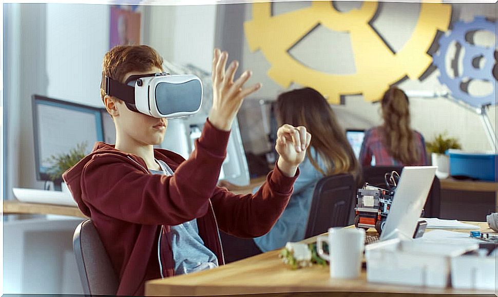 Boy using a virtual reality glasses in the classroom.