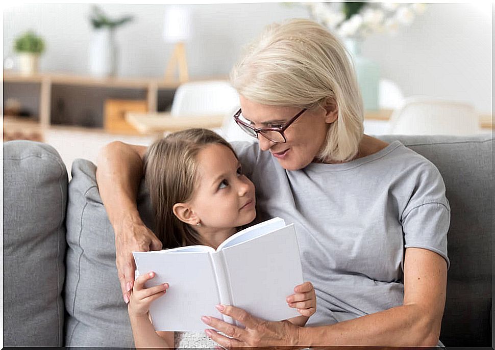 Grandmother reading one of the children's thinking stories to her granddaughter.